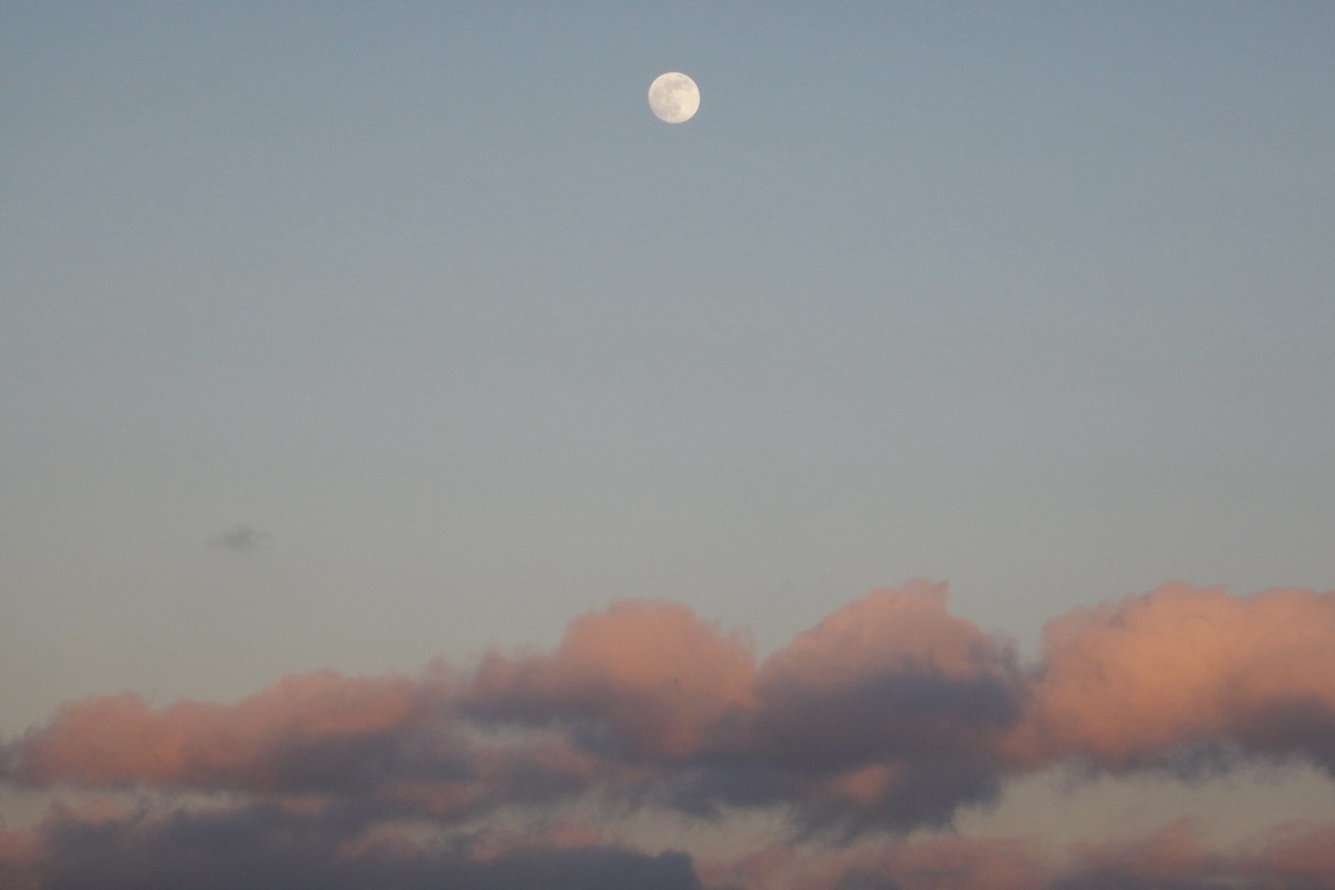 Moon rising over pastel clouds at dusk in Florence, Italy - Sky photography by Rocco Goldschmidt