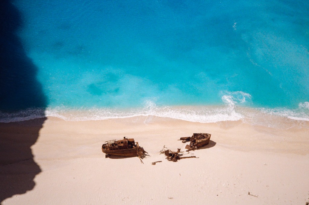 Shipwreck on Navagio Beach with turquoise water in Zakynthos, Greece - Aerial travel photography by Rocco Goldschmidt