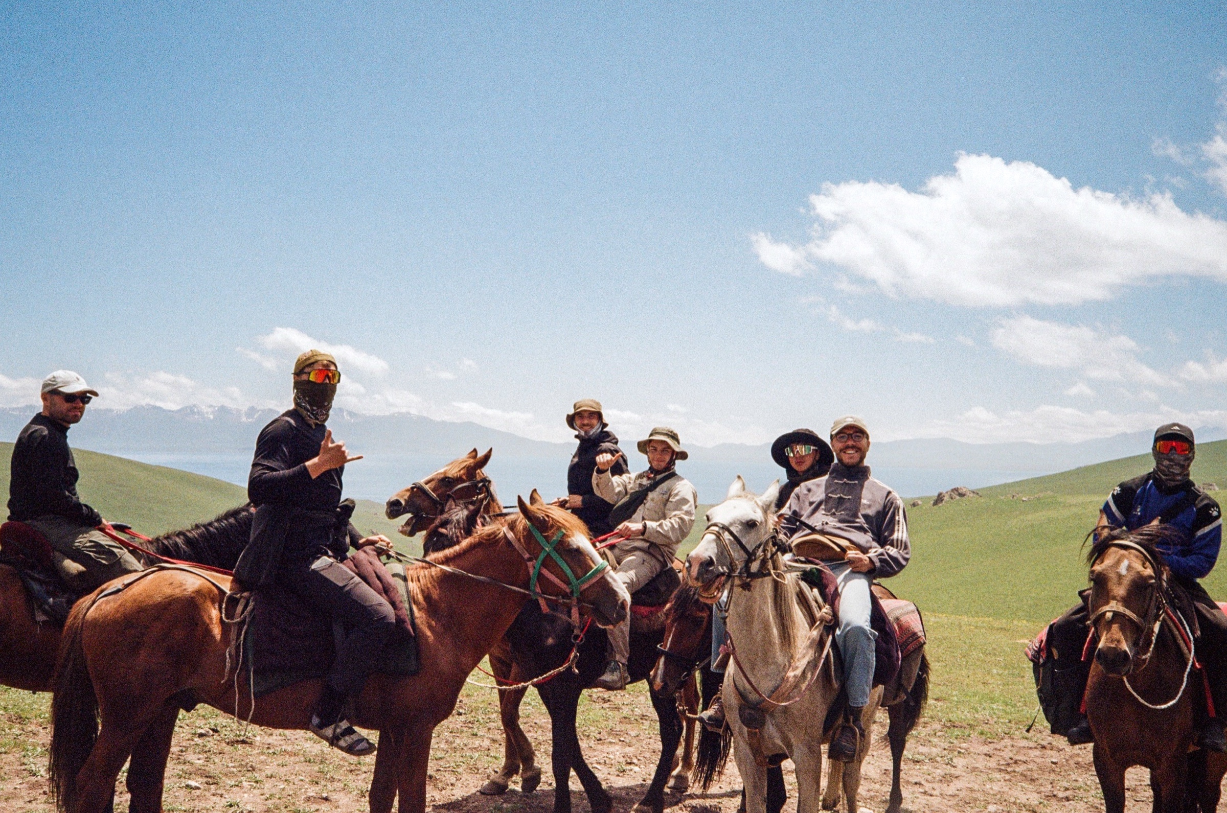 Group of trekkers on horseback in the highlands near Song-Köl, Kyrgyzstan - Travel photography by Rocco Goldschmidt