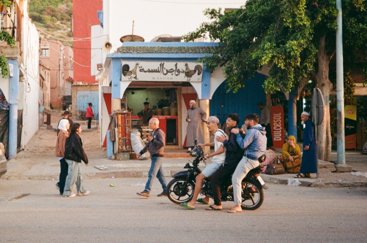 Street fruit market with vendors and Arabic signage in Aourir, Morocco - Street photography by Rocco Goldschmidt